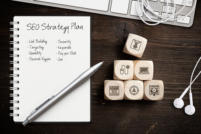 A notepad with the words seo strategy plan on it.